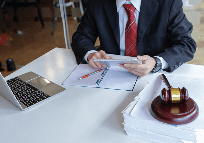 Man in suit with tablet and gavel.